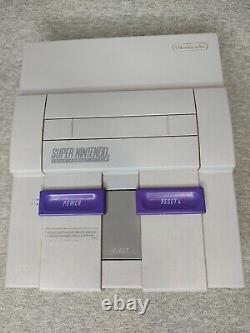 Console Super Nintendo SNES avec bundle de 2 manettes et 4 jeux testés.