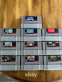 Console Super Nintendo (SNES) avec lot de 10 jeux originaux, boîtiers et couvertures.