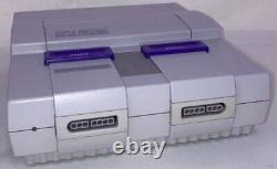 Console Super Nintendo SNES en excellente condition avec jeux et connexions.