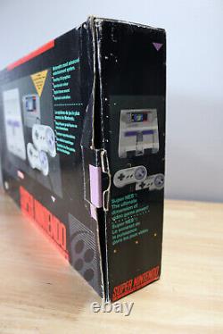 Console Super Nintendo dans sa boîte avec le jeu Super Mario World SNES authentique