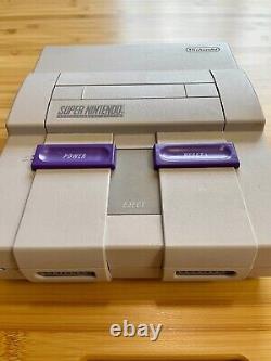 Système de jeu Super Nintendo SNES avec 4 jeux vintage non ouverts et manettes